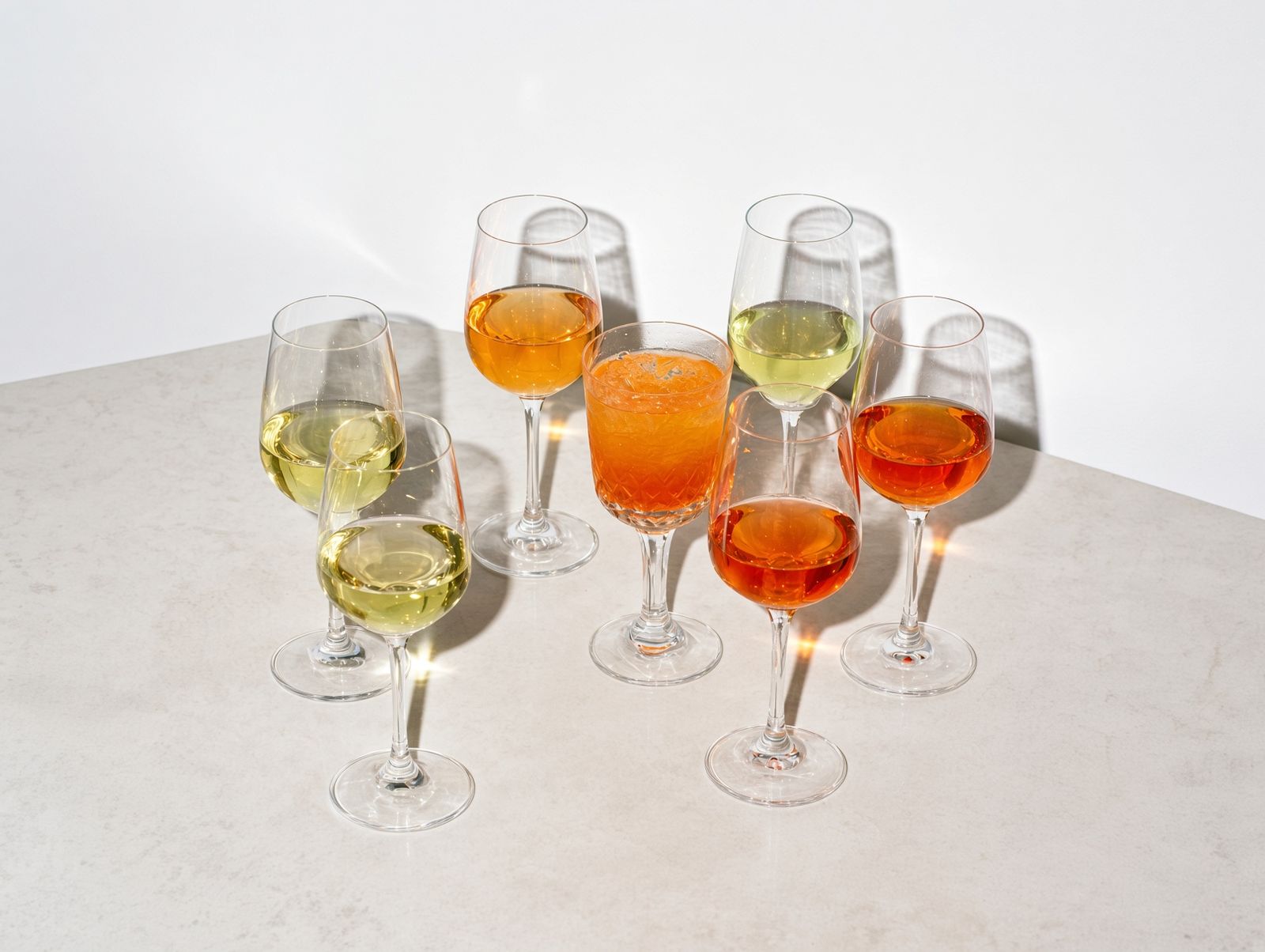 The range poured across seven glasses, with the aperitivo over ice